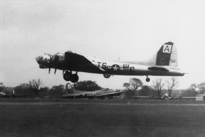 A B-17 Flying Fortress (TS-C, serial number 42-9768) of the 333rd Bomb Squadron, 94th Bomb Group, takes off in front of another B-17 Flying Fortress (CC-Z) of the 569th Bomb Squadron, 390th Bomb Group.